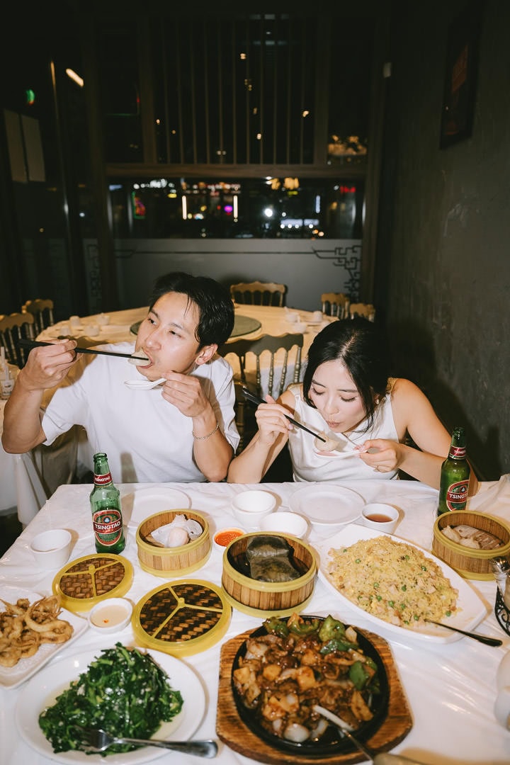 Candid engagement portrait dining in restaurant, Chinatown, Toronto