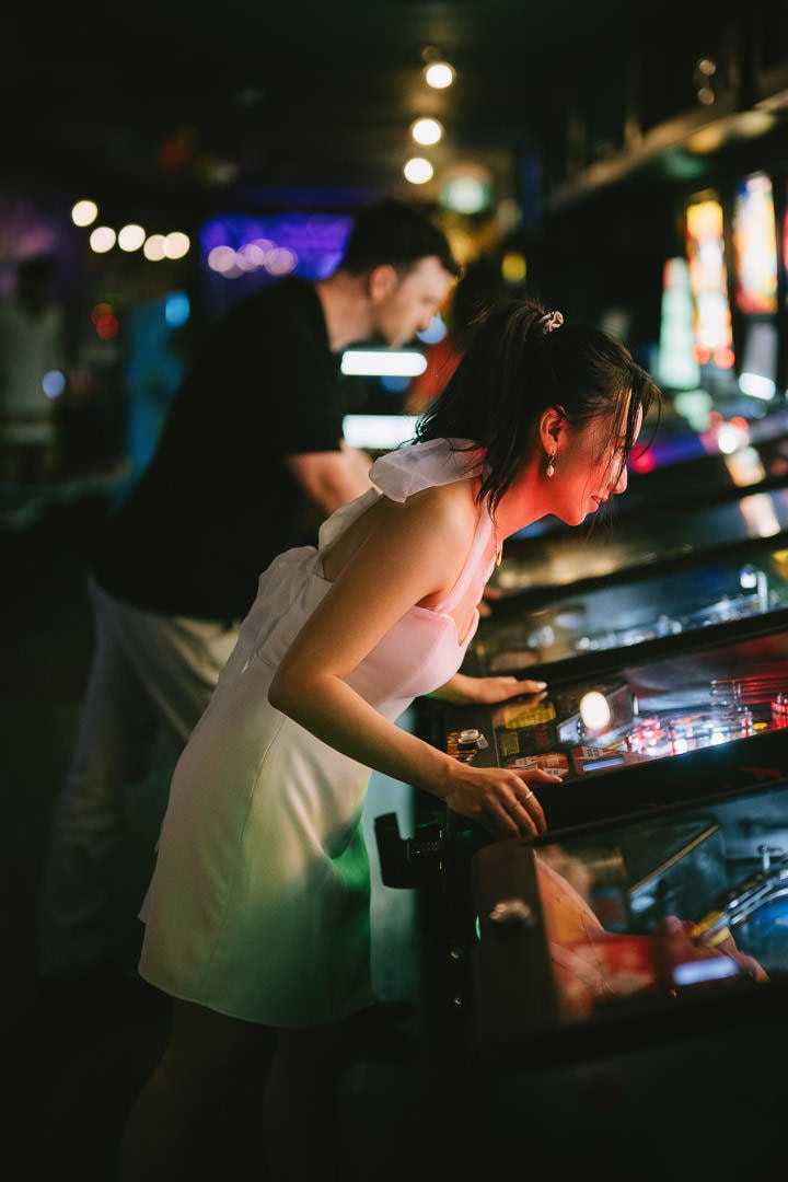Date night engagement portrait at pinball machine, Freeplay arcade, Toronto