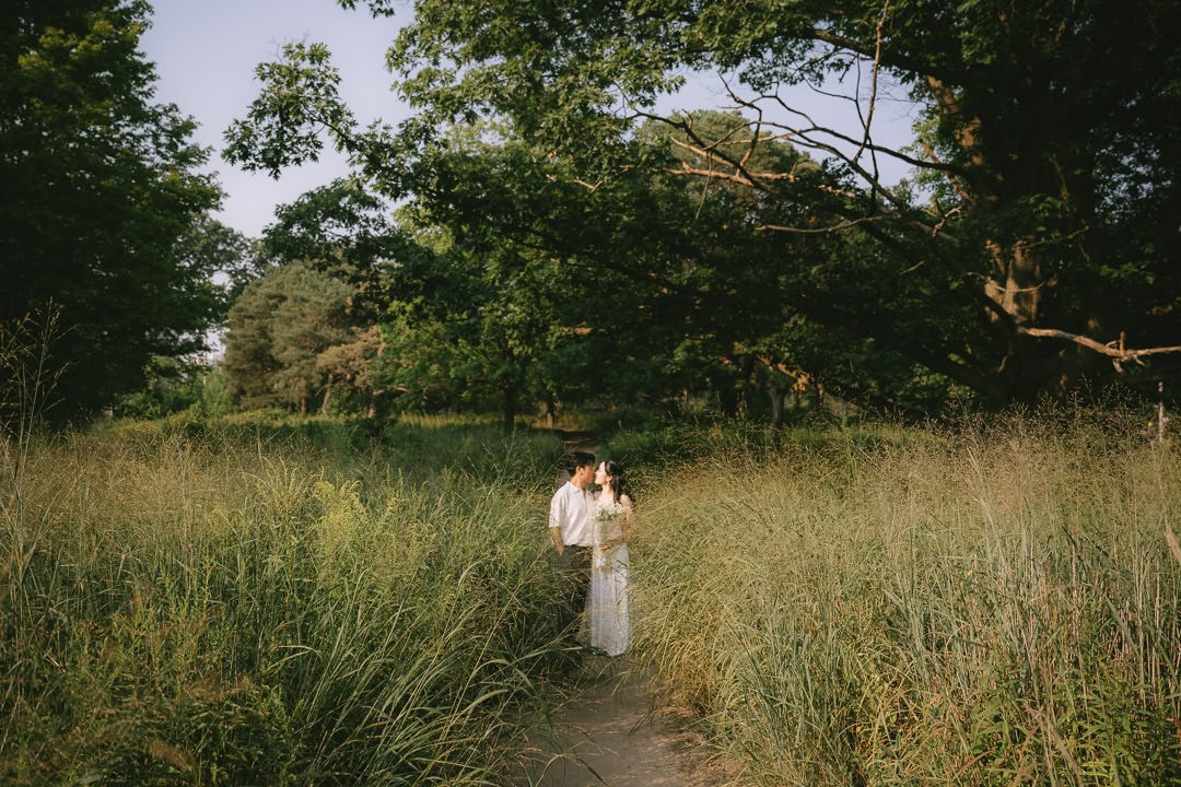 Couple in tall grass field, High Park, Toronto