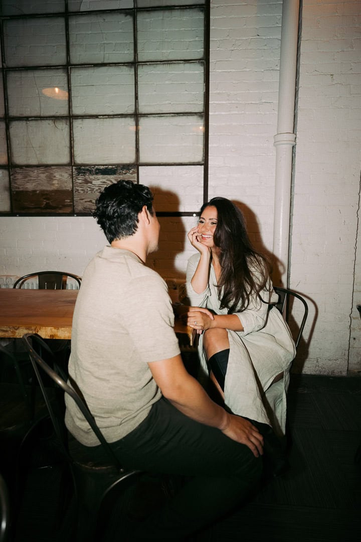 Candid engagement portrait in a bar, Kensington Market, Toronto