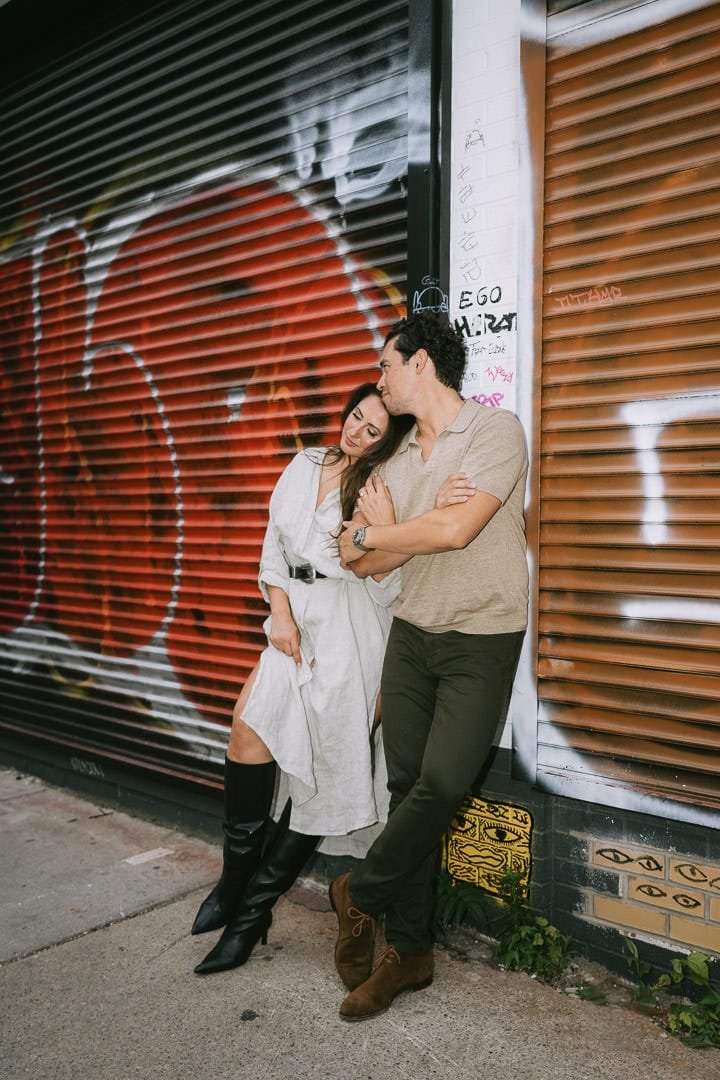 Engagement portrait against graffiti wall, Kensington Market, Toronto