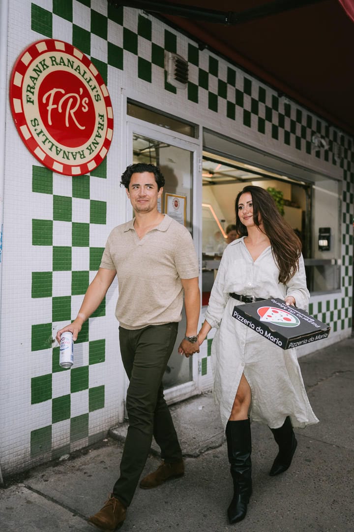 Candid engagement portrait grabbing pizza, Kensington Market, Toronto