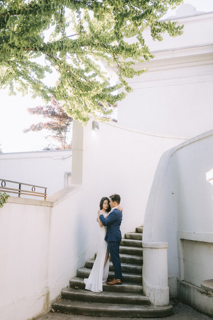 Editorial engagement portrait, Sunnyside Pavilion courtyard against white stairs, Toronto
