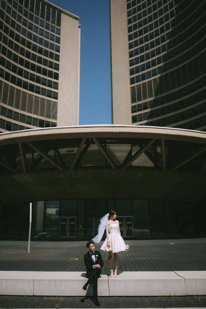high contrast daytime engagement portrait against brutalist architecture, Toronto City Hall