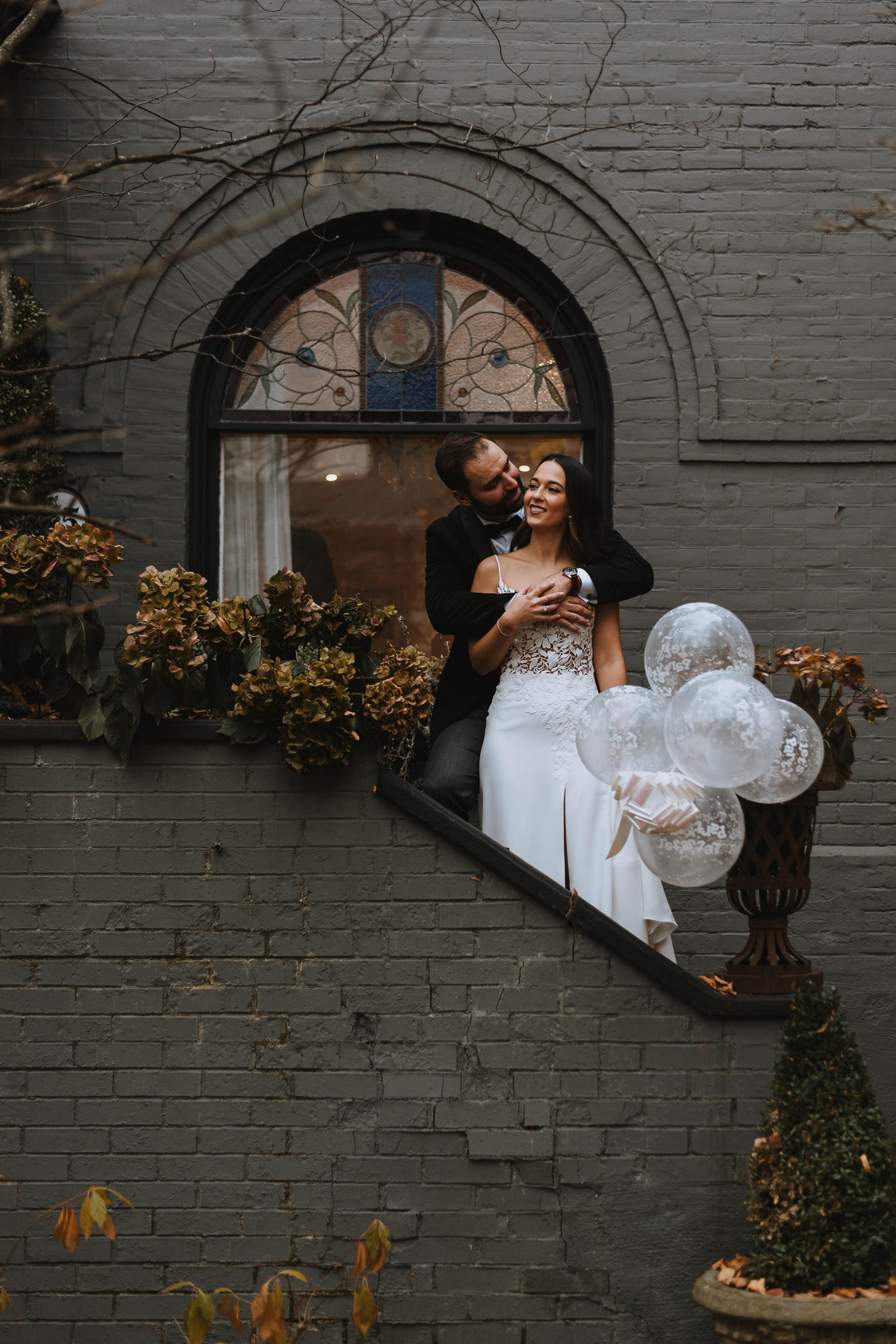 Intimate bride and groom photo surrounded by grey exterior walls